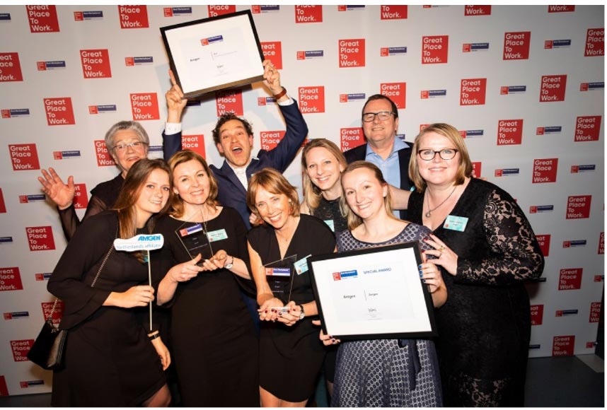 Pictures of Amgen employees pausing with awards in hand on the stage at Great Place to Work Awards ceremony 